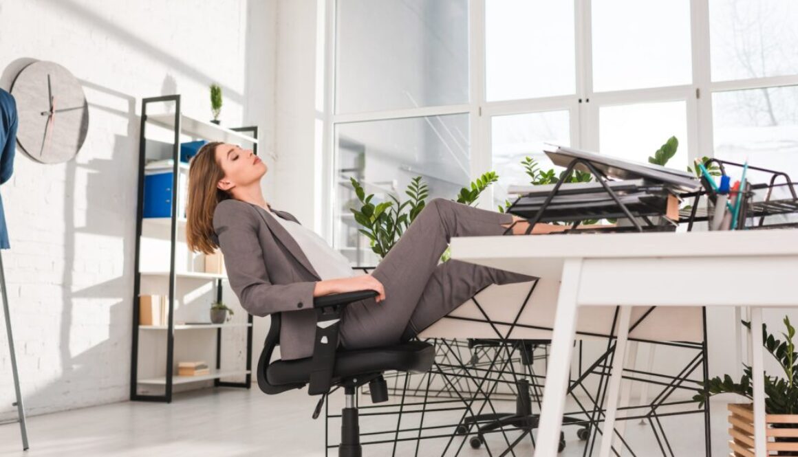 attractive businesswoman resting on chair in office